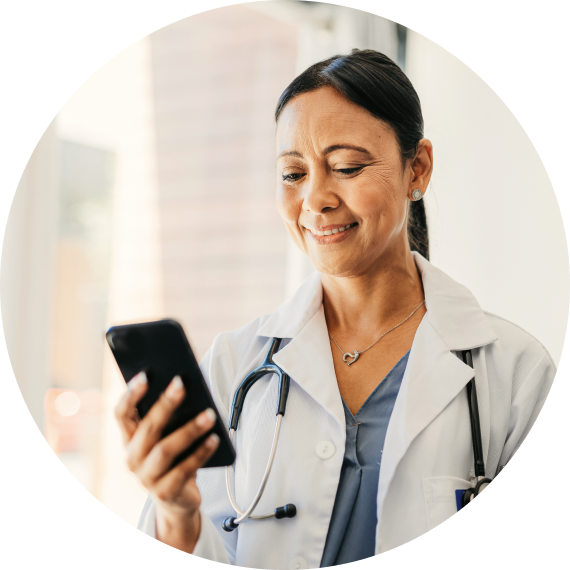 A healthcare provider using the MyCompHealth app on her phone